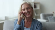 istock Smiling mature woman spend leisure time, blab on smartphone 1480833509