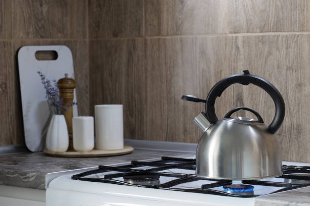 istock metal silver modern kettle on   gas stove  and utensils in kitchen 1480833689