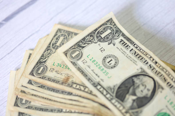 istock One dollar bills on white background. Close-up photo. 1480836204