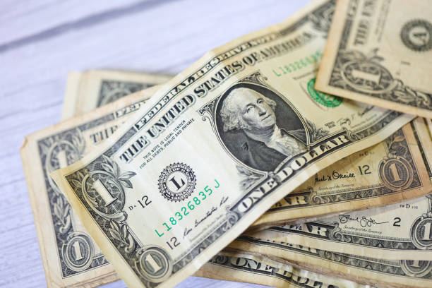 istock One dollar bills on white background. Close-up photo. 1480836218