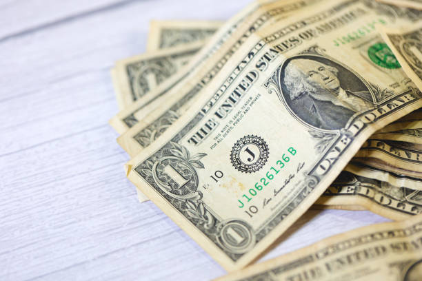 istock One dollar bills on white background. Close-up photo. 1480836235