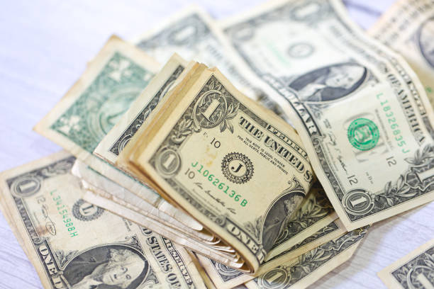 istock One dollar bills on white background. Close-up photo. 1480836279
