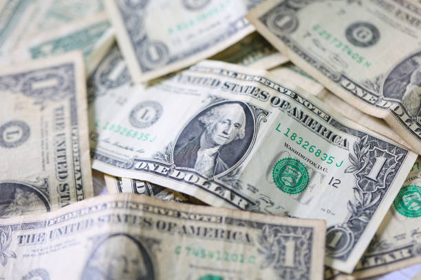 istock One dollar bills on white background. Close-up photo. 1480836840