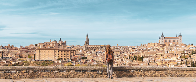 Panorama of Toledo city landscape in Spain and woman standing contempling impressive view