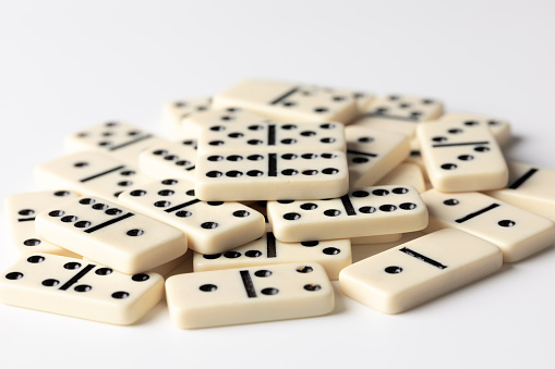 beige domino tiles on a white background photographed in close-up