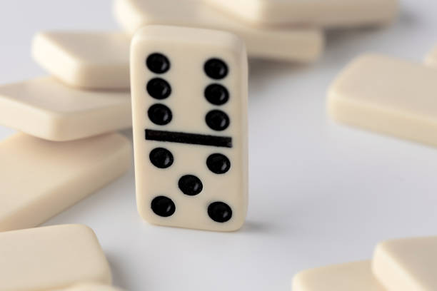 beige domino tiles on a white background photographed in close-up