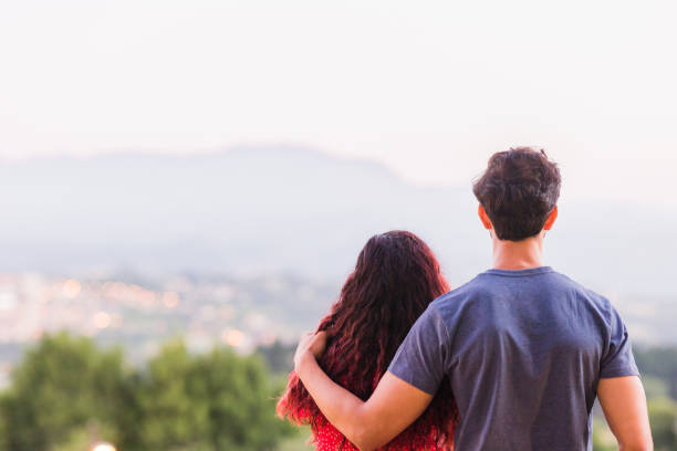 istock Unrecognizable couple hugging and dream in a future relationship while looking cityscape of Oviedo 1480842485