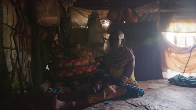 SLO MO Elderly Samburu woman inside of her tribal hut - Samburu Tribe