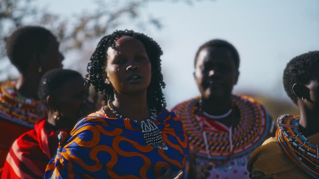 SLO MO Samburu women in traditional dresses clapping with hands