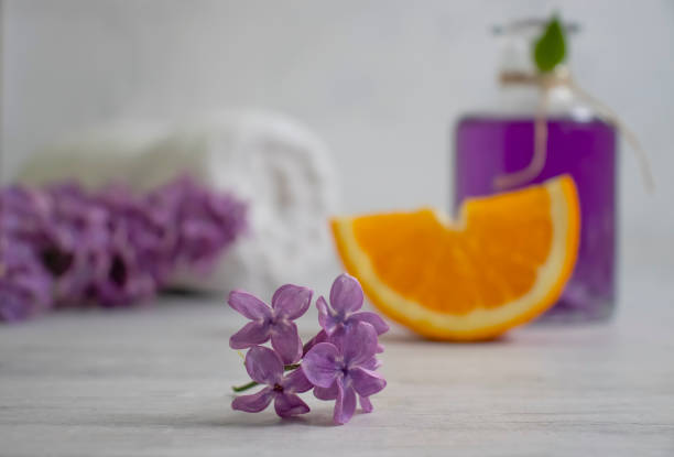 istock Cosmetic oil flower lilac on a light background 1480846628