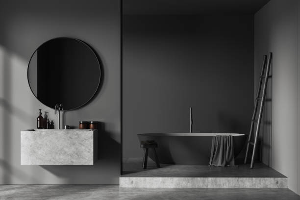 istock Grey bathroom interior with sink and bathtub on grey concrete podium. Mockup 1480850353