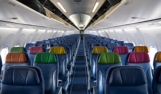 istock Empty Airplane inside cabin view with colorful seats - travel theme 1480850944