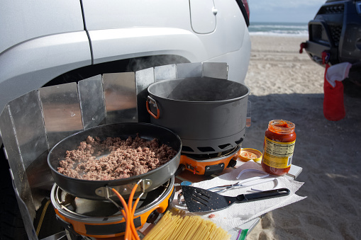 Cooking spaghetti in beachside campsite