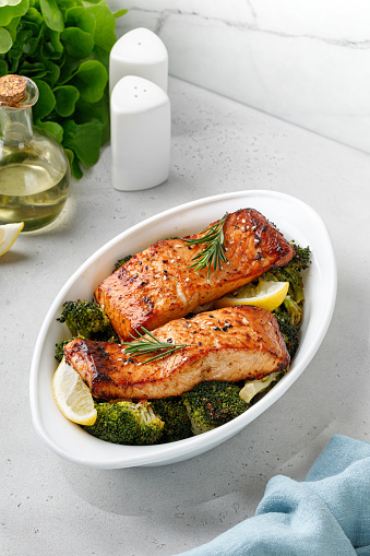 Salmon. Baked, roasted fish salmon steaks, slices. Grilled salmon,trout fillet fish in marinade with broccoli in baking dish. Diet, meal, dinner.
