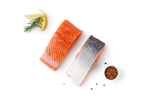 Salmon. Fresh raw uncooked salmon fillet fish, slice, steak with rosemary and pepper isolated on white background with clipping path, cut out. Top view.
