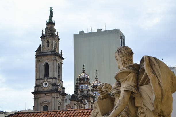 istock angel sculpture with a tower in the background 1480863468