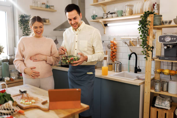 istock Positive expecting couple having video call at kitchen 1480865201
