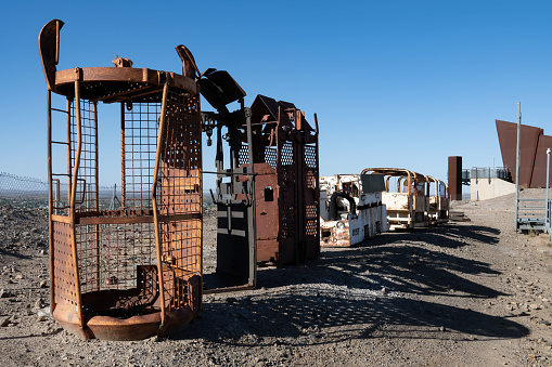 Row of rusty, dented old miners' cages once used to take miners down mine shafts. Located in Broken Hill, New South Wales, Australia.
