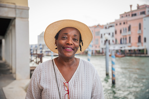 A smiling mature African American tourist on vacation in Venice in summer