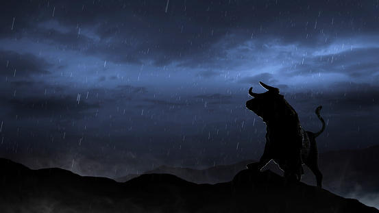 Stock Market Bull Silhouette in a Storm features the silhouette of the stock market bull on a hill with storm clouds behind and rain falling and mist at its feet.