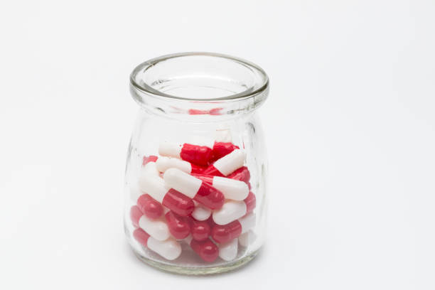 istock Jar of red and white medicine capsules 1480871864
