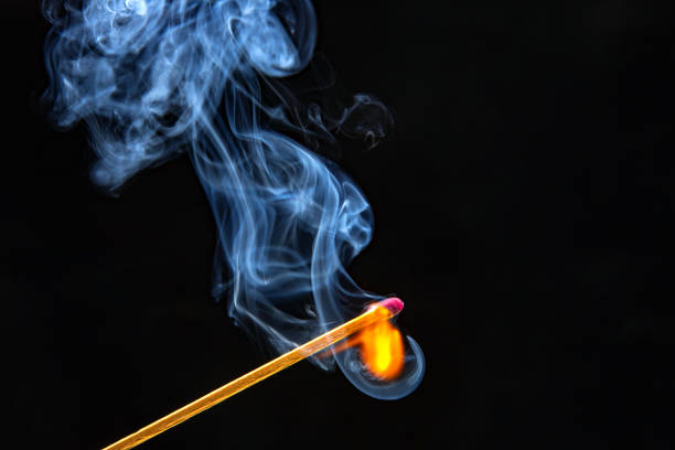 istock Flashed and burning wooden match on a dark background close-up. Bright fire and smoke from a burning tree. 1480872671