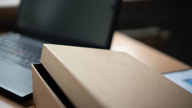 istock Laptop and cardboard box are standing on the table 1480874845