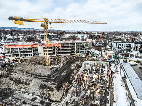 Aerial view of crane on construction site during winter day in Quebec city