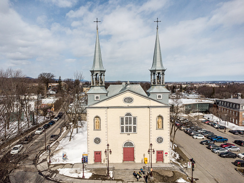 Aerial view of facade of church St-Charles-Borromée in Charlesbourg, Quebec city,  viewed from drone during winter day