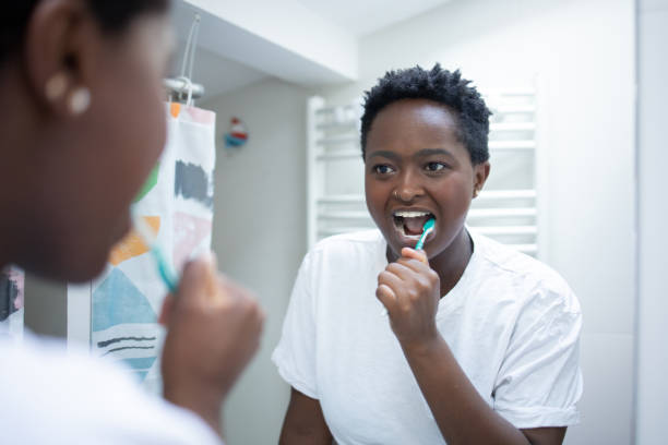 istock Happy woman brushing teeth 1480878689
