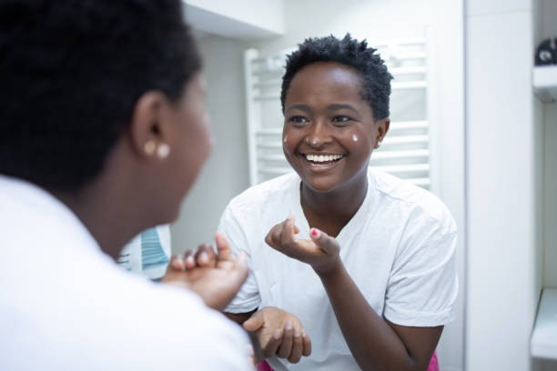 istock Handsome woman applying moisturizer to his face 1480878695