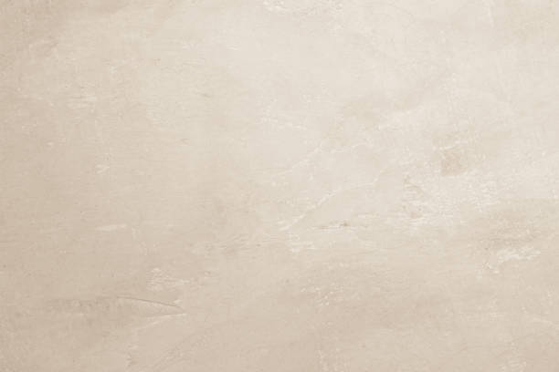 istock Colour old concrete wall texture background. Close Up retro plain cream color cement wall background texture. Design paper vintage parchment element show or advertise or promote product on display. 1480878802
