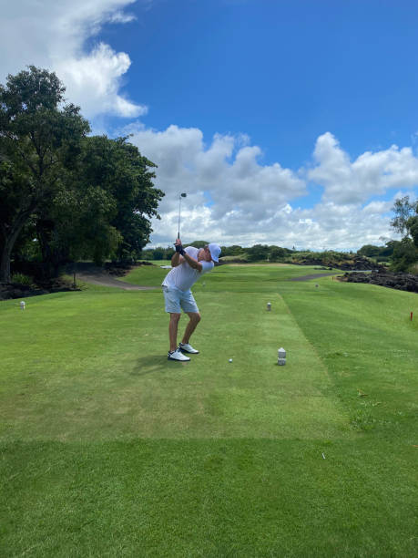 Golfer hitting field with club during summer vacation Golfer hitting field with club during summer vacation. Golf game golfer swinging club stock pictures, royalty-free photos & images