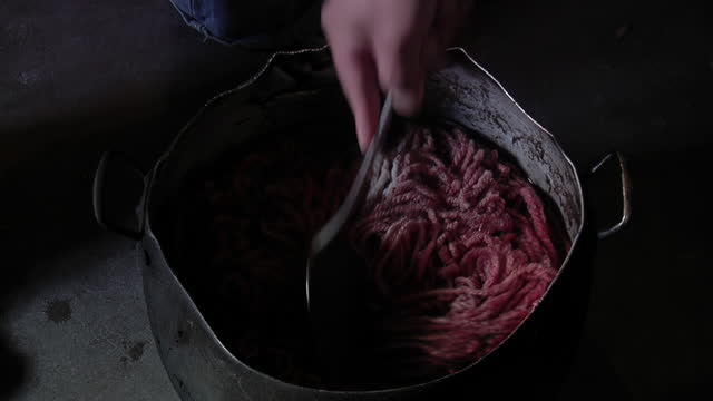 Dye from Natural Organic Ingredients, Woman Using Natural Beets for Dyeing Fabric on a Dye Pot in Her House. Close Up.