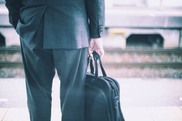 istock Businessman back view with bag 1480886488