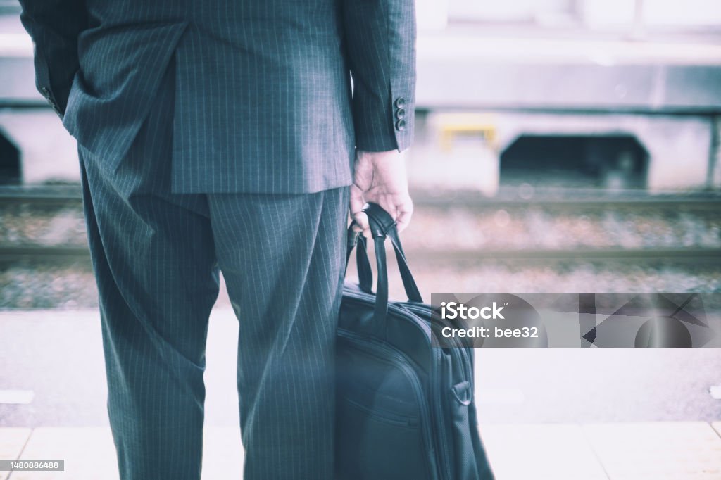 Businessman back view with bag At The Edge Of Stock Photo