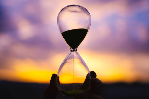 istock Sunset and glass hourglass silhouette 1480887156