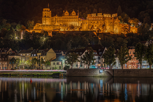 Illuminated Heidelberg Castle at night above Neckar River. Heidelberg, Baden-Württemberg, Germany, Aug. 2022