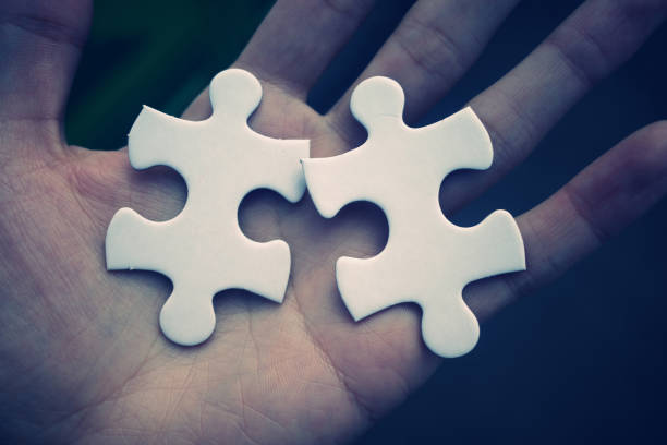 istock Hands of a man with two puzzle pieces 1480887386