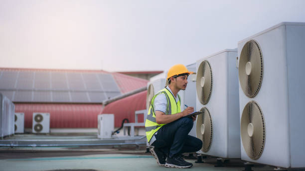istock Engineers is checking the air conditioning cooling system of a major building or industrial facility. Background is solar cell on the roof. 1480889765