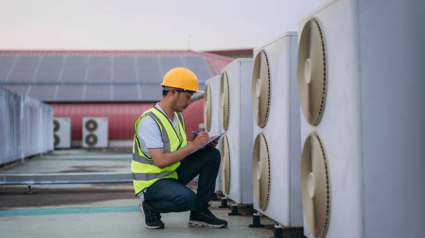 istock Engineers is checking the air conditioning cooling system of a major building or industrial facility. Background is solar cell on the roof. 1480890326