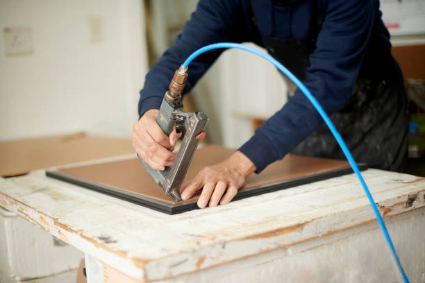 istock Carpentry hands, pneumatic stapler gun and wood while working on production at industrial workshop. Worker man with glue tools for manufacturing furniture with frame for creativity in craft factory 1480894593