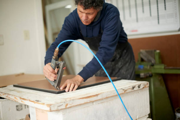 istock Frame, art and creative with a man designer using a staple gun on a picture in his small business workshop. Manufacturing, industry and craft with a male employee, artist or entrepreneur in a studio 1480894597