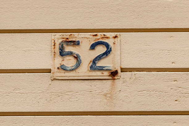 istock 52 number plaque on timber with cream paint peeling and rust showing old age and vintage. House or business number best for online recaptcha and verification processes. Pick a number bingo games, brochures. European style 1480895549