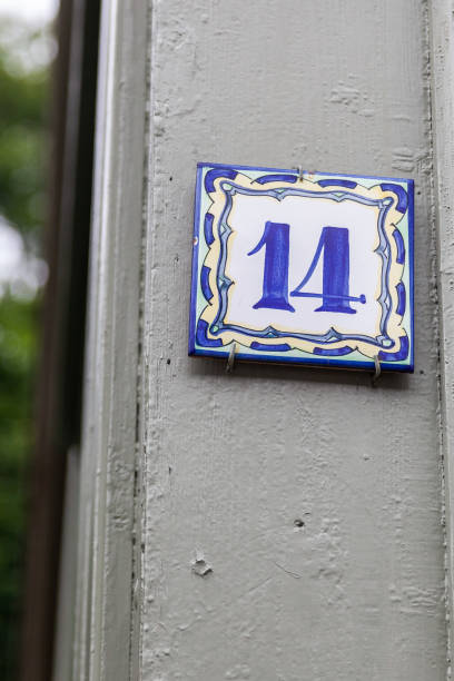 istock 14 ceramic decorative number plaque on timber with white paint peeling show old age and vintage. 1480895560