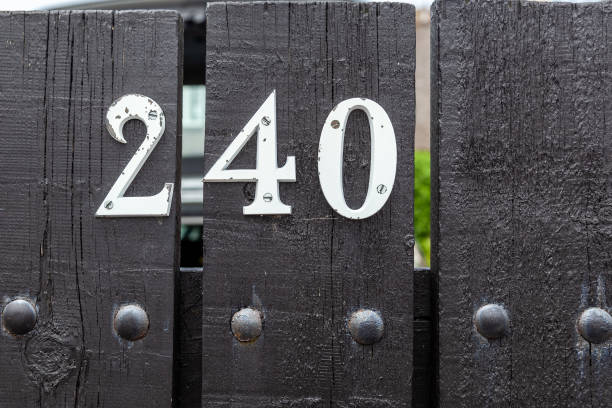 istock 240 number plaque on black painted timber fence. 1480895565