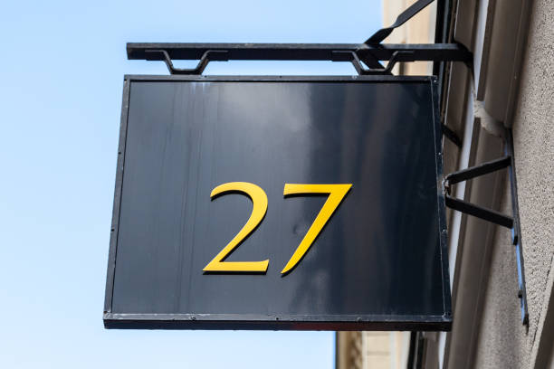 istock 27 numerals in yellow plastic stuck on black metal swing frame. 1480895573