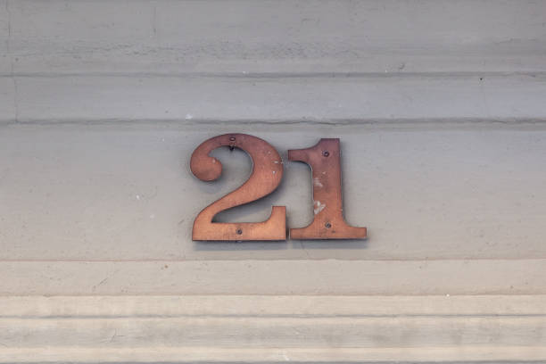 istock 21 numerals in copper fixed against a cream shiplap house wall. 1480895577