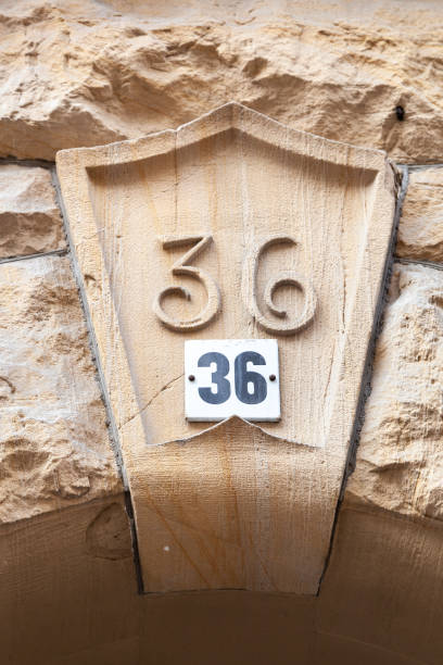 istock 36 numerals in steel painted sandstone fixed against a sandstone door lintel in an upperclass district. 1480895578