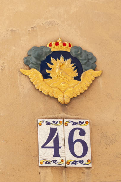 istock 46 ceramic decorative number plaque on yellow cement rendered wall with local and contry badge above. 1480895579